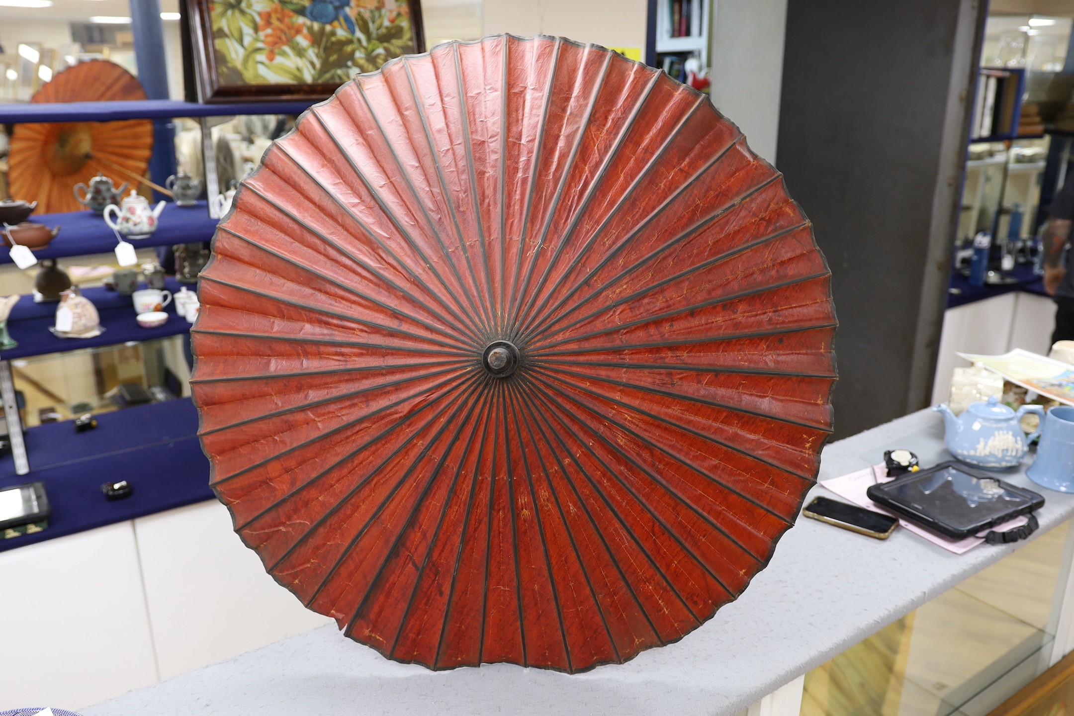 A Burmese painted parasol with white metal handle, 62cm, and one other parasol